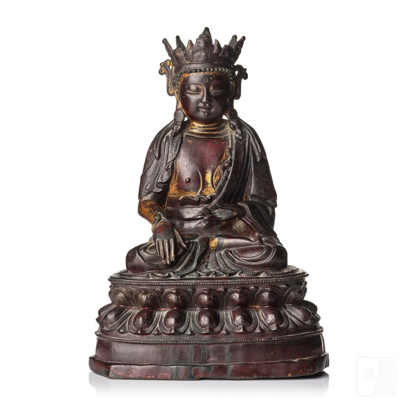 A bronze sculpture of a crowned Buddha,